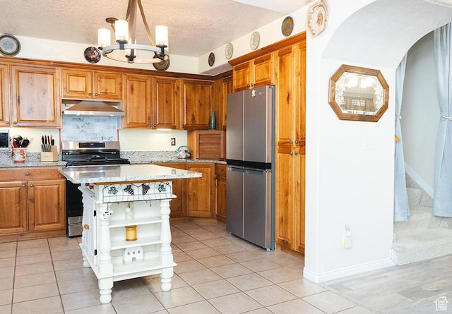 435 W Cobblestone Dr, Providence, UT 84332 - kitchen with appliances with stainless steel finishes, open shelves, under cabinet range hood, a chandelier, and brown cabinetry
