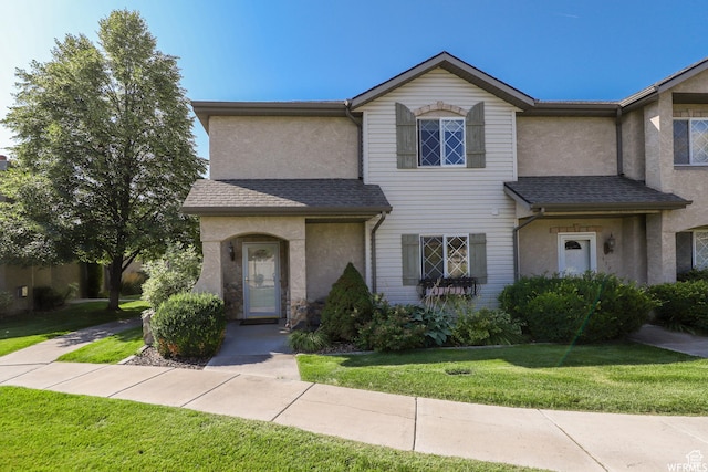 435 W Cobblestone Dr, Providence, UT 84332 - view of front of property with stucco siding, a front lawn, and roof with shingles