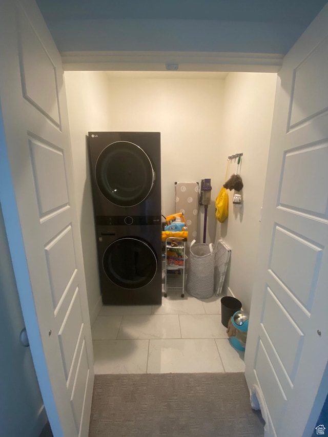 4678 W Vermillion Dr S, South Jordan, UT 84009 - laundry area with stacked washer / dryer and tile patterned flooring