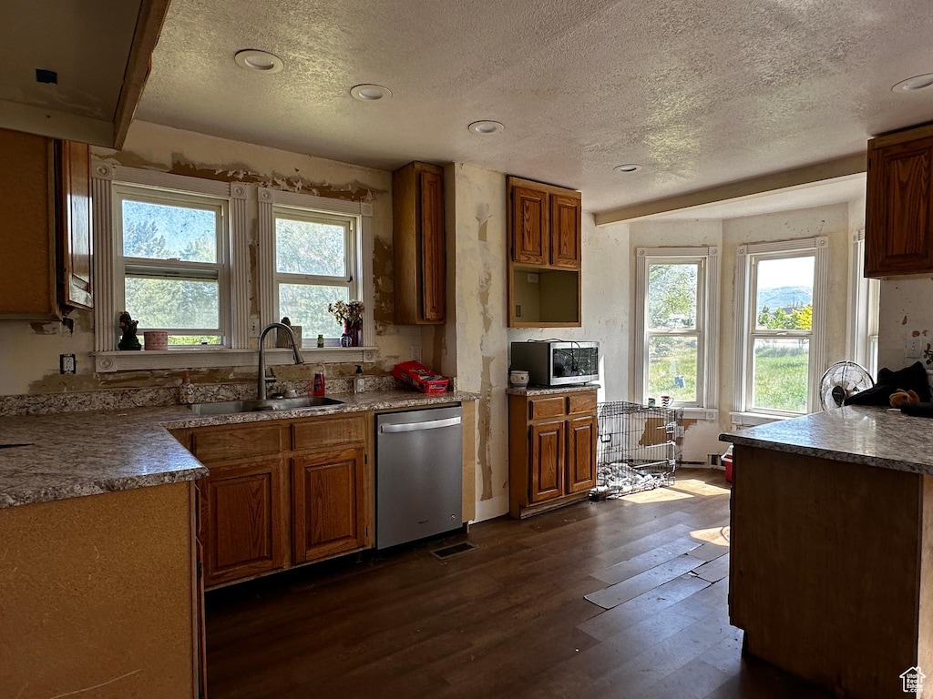 375 E 200 N, Spring City, UT 84662 - kitchen with stainless steel appliances, a textured ceiling, dark wood-style flooring, healthy amount of natural light, and brown cabinetry
