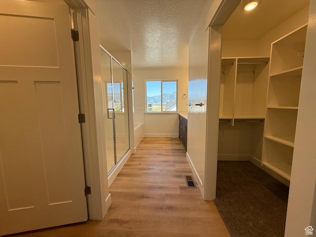 3298 S 1000 W, Nibley, UT 84321 - corridor featuring light wood-style floors and a textured ceiling