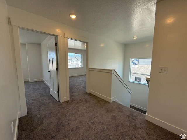 3298 S 1000 W, Nibley, UT 84321 - hallway with dark colored carpet, an upstairs landing, a textured ceiling, and recessed lighting