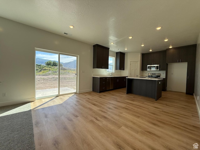 3298 S 1000 W, Nibley, UT 84321 - kitchen with stainless steel appliances, light countertops, recessed lighting, light wood-style flooring, and a center island