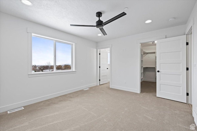 2230 S 635 W Unit C, Perry, UT 84302 - unfurnished bedroom with light carpet, a walk in closet, recessed lighting, a closet, and ceiling fan