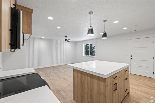 2230 S 635 W Unit C, Perry, UT 84302 - kitchen featuring light wood finished floors, a textured ceiling, recessed lighting, decorative light fixtures, and light countertops