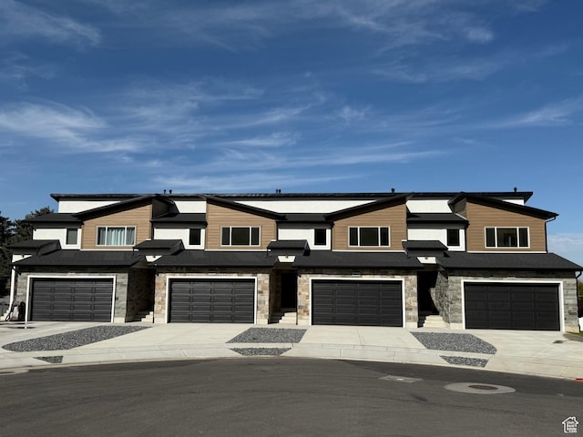 2230 S 635 W Unit C, Perry, UT 84302 - view of front of house featuring a garage, stone siding, and driveway