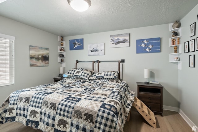6447 W Arranmore Dr, South Jordan, UT 84009 - bedroom featuring wood finished floors and a textured ceiling