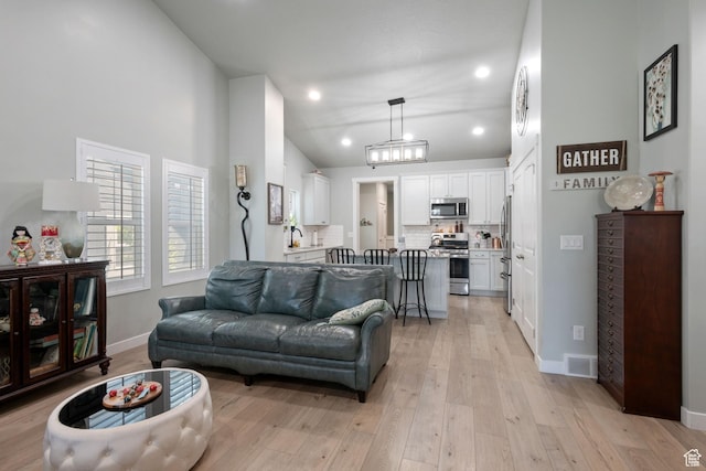 6447 W Arranmore Dr, South Jordan, UT 84009 - living room with light wood-style flooring, vaulted ceiling, and recessed lighting