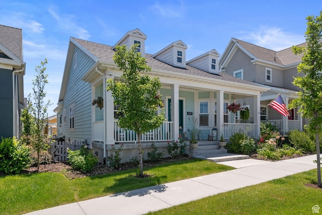 6447 W Arranmore Dr, South Jordan, UT 84009 - view of front of house featuring covered porch and a front lawn