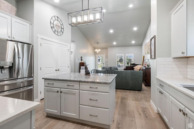 6447 W Arranmore Dr, South Jordan, UT 84009 - kitchen featuring stainless steel fridge, a chandelier, recessed lighting, backsplash, and white cabinets