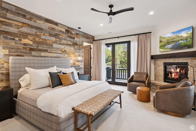 1427 Eagle Way, Park City, UT 84060 - bedroom with access to outside, wooden walls, a stone fireplace, recessed lighting, and carpet floors