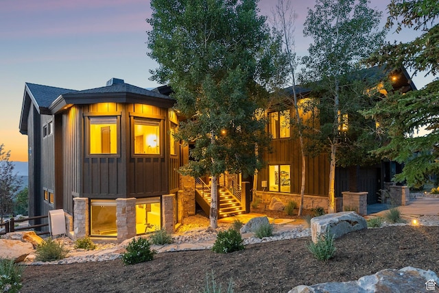 1427 Eagle Way, Park City, UT 84060 - view of front of home with board and batten siding, stone siding, stairway, and a shingled roof