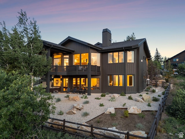 1427 Eagle Way, Park City, UT 84060 - back of property at dusk featuring a chimney and a patio area