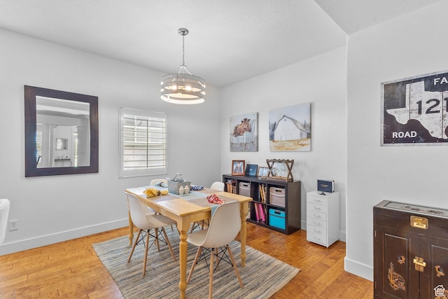 4269 W Lake Brg S, South Jordan, UT 84009 - dining space featuring a chandelier and light wood-type flooring