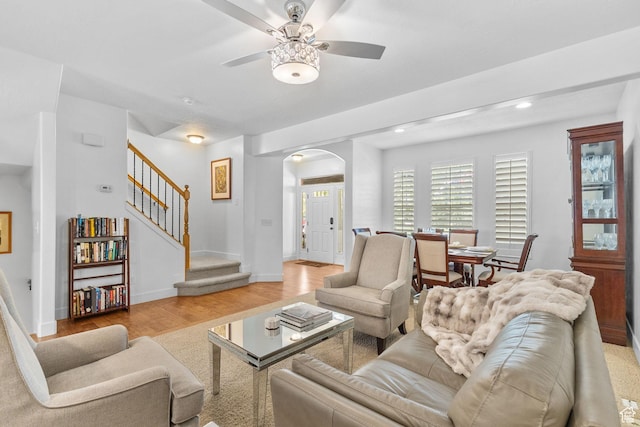 4269 W Lake Brg S, South Jordan, UT 84009 - living room featuring arched walkways, a ceiling fan, stairs, light wood-style floors, and recessed lighting