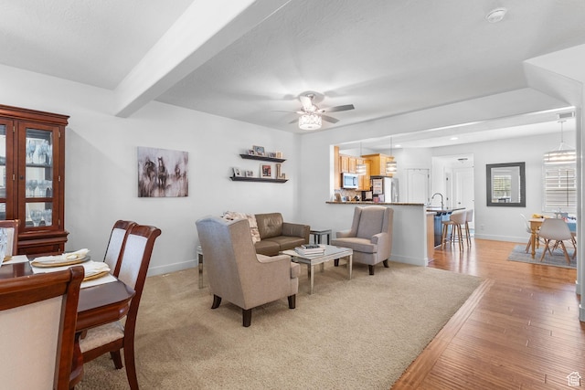 4269 W Lake Brg S, South Jordan, UT 84009 - living area with light wood-type flooring, a ceiling fan, and beamed ceiling
