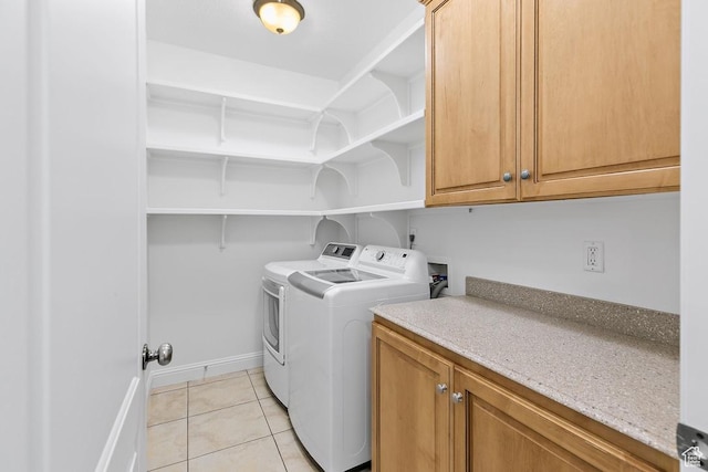 181 N 1200 W Unit 103, Orem, UT 84057 - laundry area featuring washing machine and dryer, cabinet space, and light tile patterned flooring