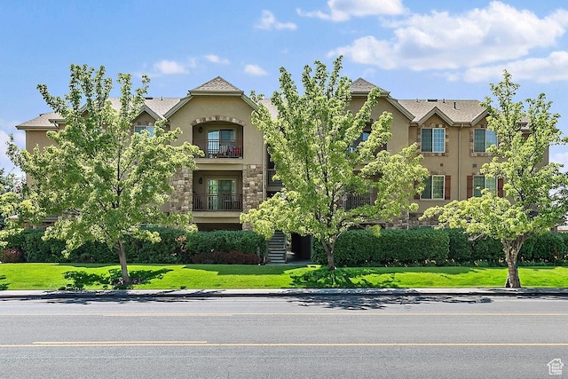 181 N 1200 W Unit 103, Orem, UT 84057 - view of front of property with stucco siding, a balcony, stone siding, and stairs