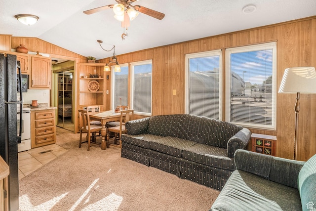 1225 N Dixie Downs Unit 119, St George, UT 84770 - living room with wooden walls, lofted ceiling, healthy amount of natural light, ceiling fan, and light tile patterned floors