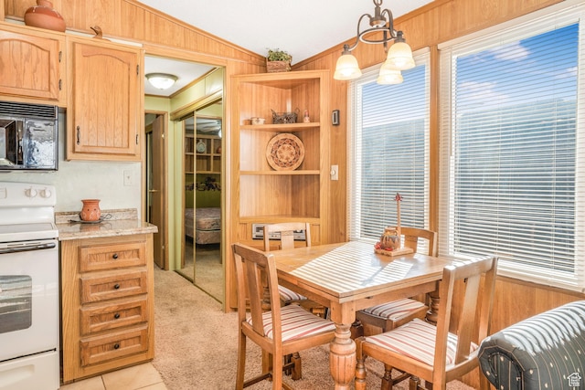 1225 N Dixie Downs Unit 119, St George, UT 84770 - dining room with lofted ceiling, wood walls, built in features, light tile patterned flooring, and light carpet