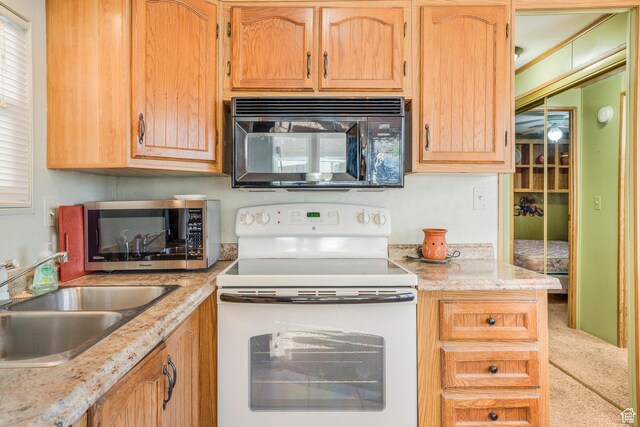 1225 N Dixie Downs Unit 119, St George, UT 84770 - kitchen with black microwave, white range with electric stovetop, stainless steel microwave, and carpet floors