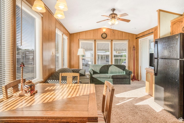 1225 N Dixie Downs Unit 119, St George, UT 84770 - dining room with lofted ceiling, wooden walls, ceiling fan, healthy amount of natural light, and light colored carpet