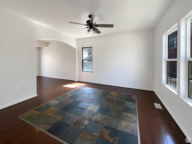 6842 W Grevillea Ln, West Jordan, UT 84081 - empty room with a ceiling fan, arched walkways, and wood finished floors