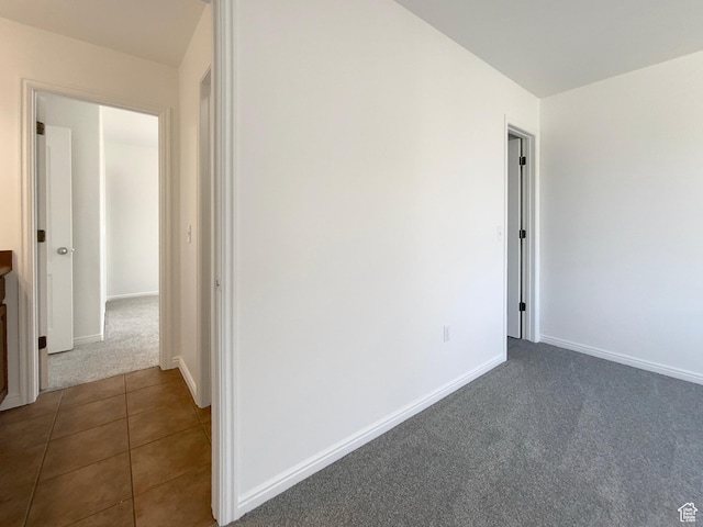 6842 W Grevillea Ln, West Jordan, UT 84081 - empty room with dark colored carpet and dark tile patterned floors