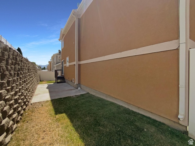 6842 W Grevillea Ln, West Jordan, UT 84081 - view of property exterior featuring a patio area and stucco siding