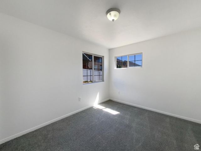 6842 W Grevillea Ln, West Jordan, UT 84081 - empty room featuring dark carpet and baseboards
