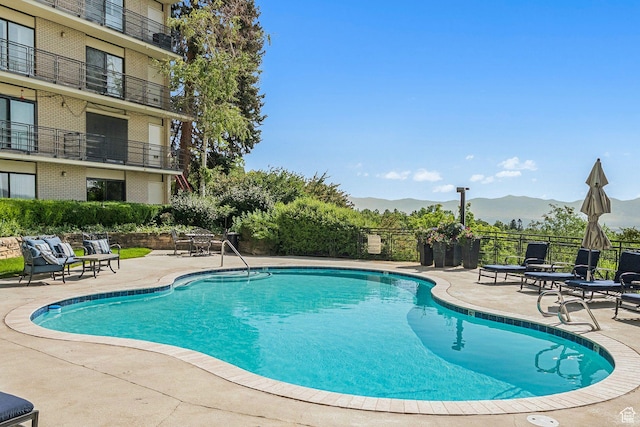 900 S Donner Way E Unit 405, Salt Lake City, UT 84108 - view of pool featuring a patio area and a mountain view