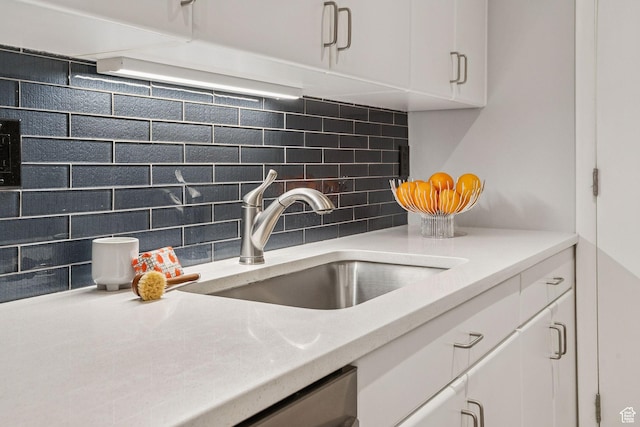 900 S Donner Way E Unit 405, Salt Lake City, UT 84108 - kitchen view of backsplash, white cabinetry, and light countertops