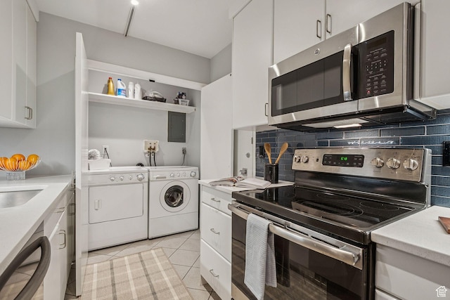 900 S Donner Way E Unit 405, Salt Lake City, UT 84108 - kitchen with stainless steel appliances, independent washer and dryer, light countertops, backsplash, and white cabinets