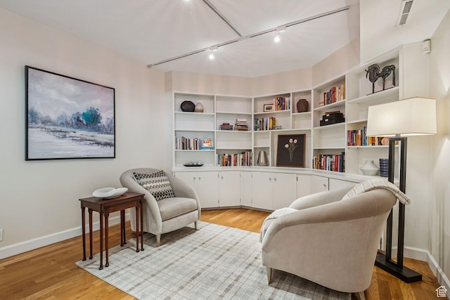 900 S Donner Way E Unit 405, Salt Lake City, UT 84108 - living area with rail lighting and light wood-style flooring
