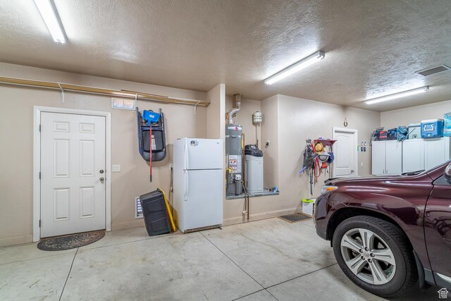 1430 W 365 N, Hurricane, UT 84737 - garage featuring freestanding refrigerator and secured water heater