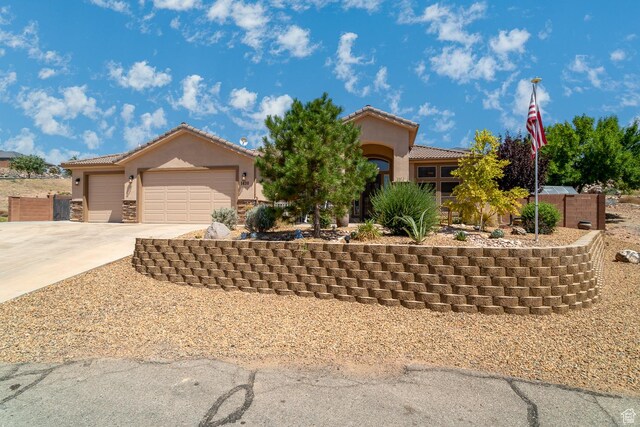 1430 W 365 N, Hurricane, UT 84737 - mediterranean / spanish-style home with stucco siding, driveway, a tiled roof, and an attached garage
