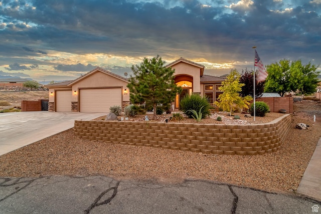 1430 W 365 N, Hurricane, UT 84737 - view of front of house featuring driveway, an attached garage, stucco siding, and a tiled roof