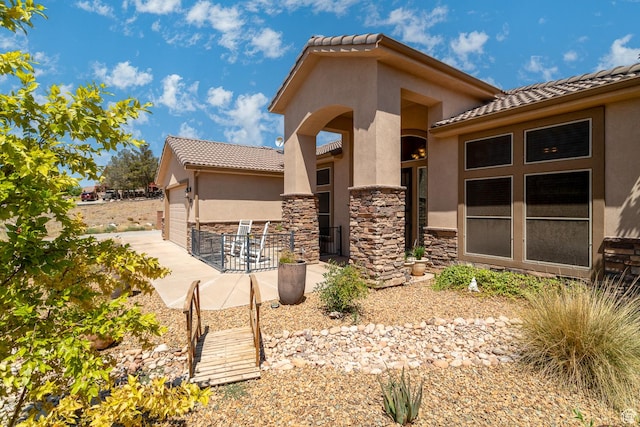 1430 W 365 N, Hurricane, UT 84737 - rear view of house with stucco siding, stone siding, and a tile roof