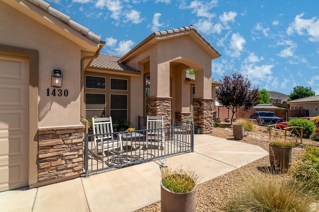 1430 W 365 N, Hurricane, UT 84737 - property entrance featuring stone siding, stucco siding, and a tile roof
