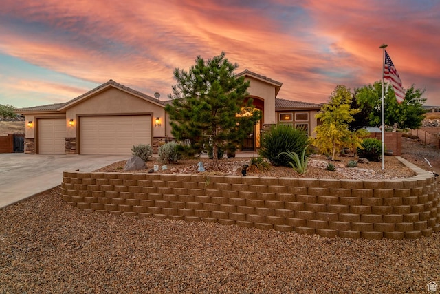 1430 W 365 N, Hurricane, UT 84737 - view of front of house featuring driveway, a tile roof, stucco siding, an attached garage, and stone siding