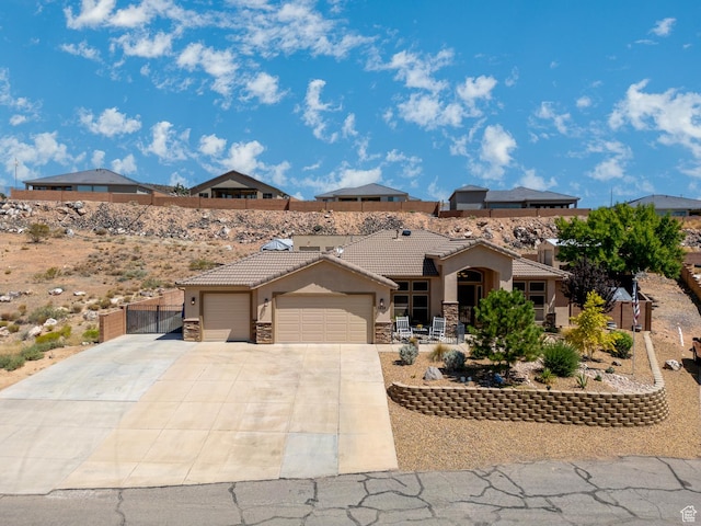 1430 W 365 N, Hurricane, UT 84737 - view of front facade featuring stucco siding, an attached garage, driveway, a tile roof, and stone siding