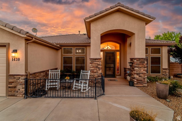 1430 W 365 N, Hurricane, UT 84737 - view of exterior entry featuring stone siding, stucco siding, and a tiled roof