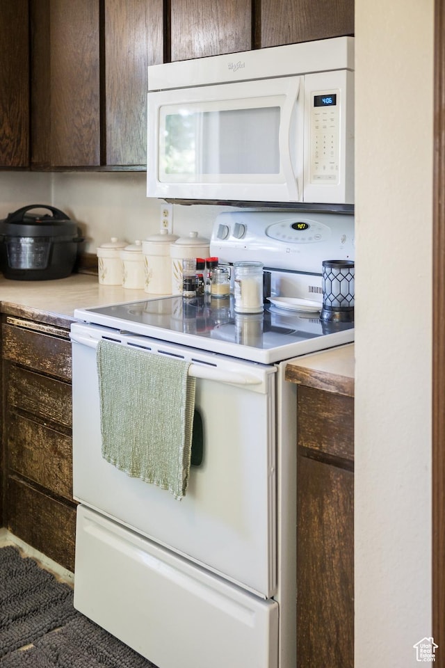 454 W 650 N, Vernal, UT 84078 - kitchen with white appliances, dark brown cabinets, and light countertops