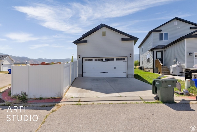 1789 N Aaron Dr E, Tooele, UT 84074 - traditional home with driveway, an outbuilding, and a mountain view