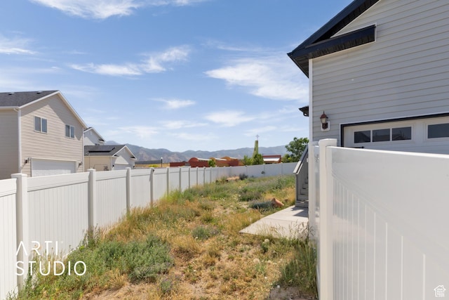 1789 N Aaron Dr E, Tooele, UT 84074 - view of yard with a mountain view and an attached garage