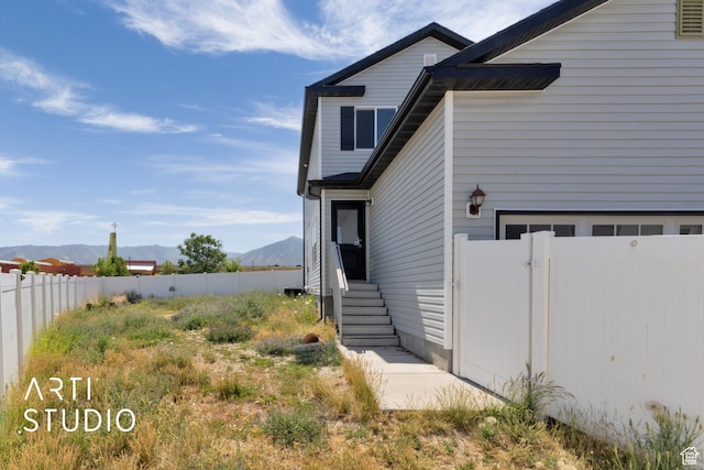 1789 N Aaron Dr E, Tooele, UT 84074 - view of home's exterior with a mountain view and a garage