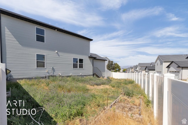 1789 N Aaron Dr E, Tooele, UT 84074 - view of side of home featuring a vegetable garden