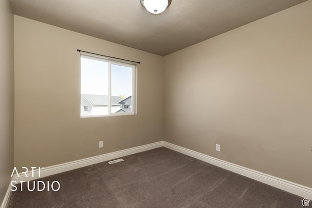 1789 N Aaron Dr E, Tooele, UT 84074 - spare room with dark colored carpet and baseboards