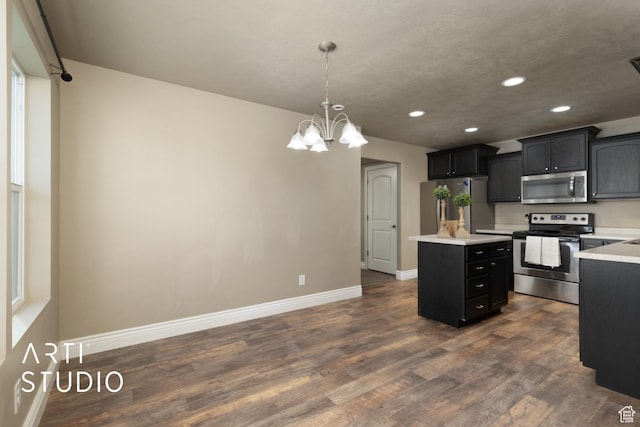 1789 N Aaron Dr E, Tooele, UT 84074 - kitchen with stainless steel appliances, a kitchen island, recessed lighting, light countertops, and a chandelier