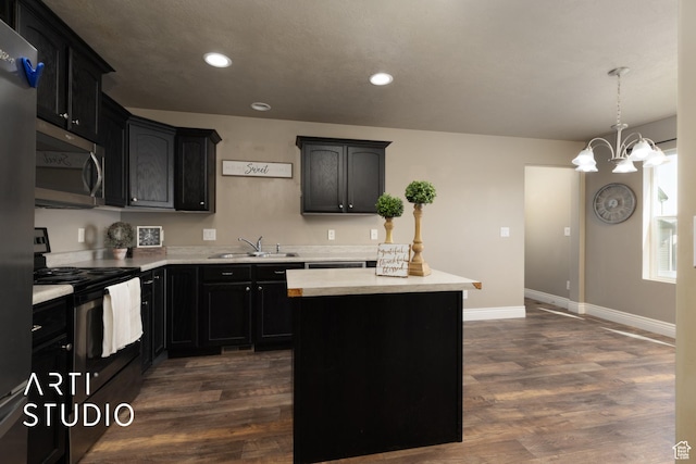 1789 N Aaron Dr E, Tooele, UT 84074 - kitchen featuring appliances with stainless steel finishes, recessed lighting, light countertops, dark wood-style floors, and a center island